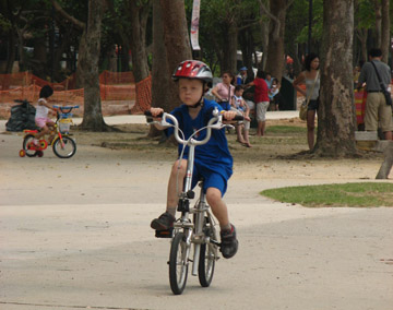 Small boy riding Jz88 folding bicycle in East Coast Park Singapore